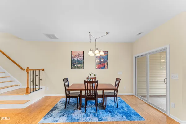 a view of a dining room with furniture wooden floor and a chandelier