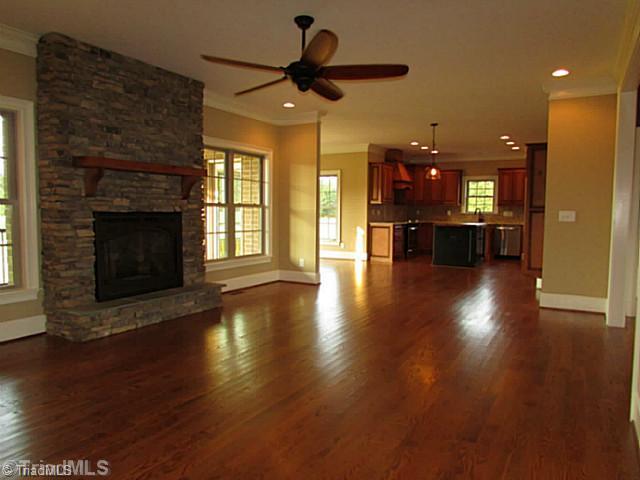 6303 Rylan Court Browns Summit, NC 27214 - Photo 14 of 14 Den/Family/Great Room. This warm open floor plan allows flexible space for your enjoyment. The stone fireplace is flanked by windows which makes a lovely centerpiece!