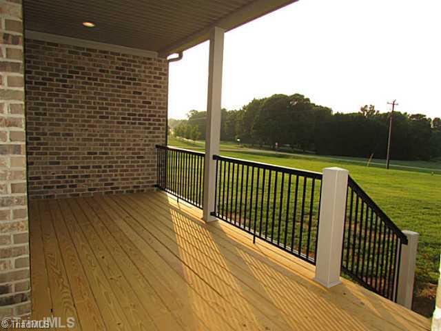 6303 Rylan Court Browns Summit, NC 27214 - Photo 12 of 14 Patio/Deck. Covered porches in the front and back of the home provide shelter to enjoy the view.