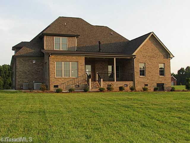 6303 Rylan Court Browns Summit, NC 27214 - Photo 13 of 14 Exterior Back. Nestled on .93 acres for privacy!