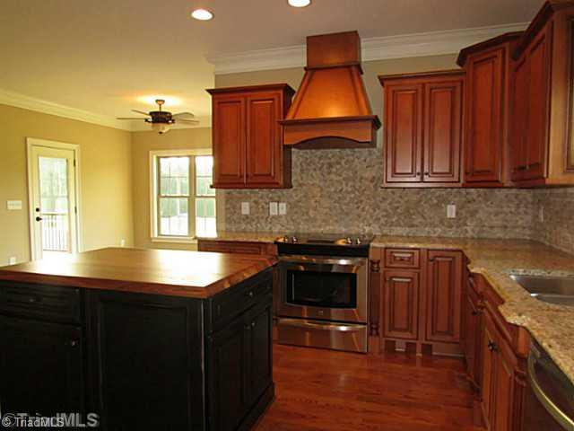Kitchen. Granite counters, 42" cabinets, tile backsplash, center island, and stainless steel appliances complete this chef s kitchen!