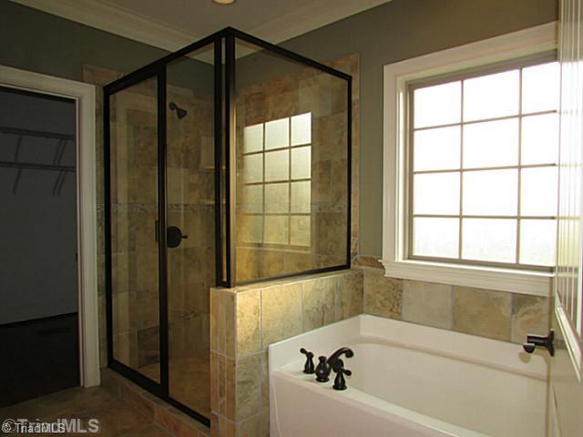 Master Bath/Spa. The master bath is fit for royalty! Tile abounds as well as granite double vanities along with a spacious walk-in closet!