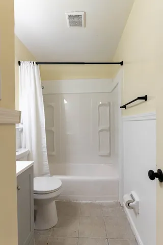 a bathroom with a shower and a toilet