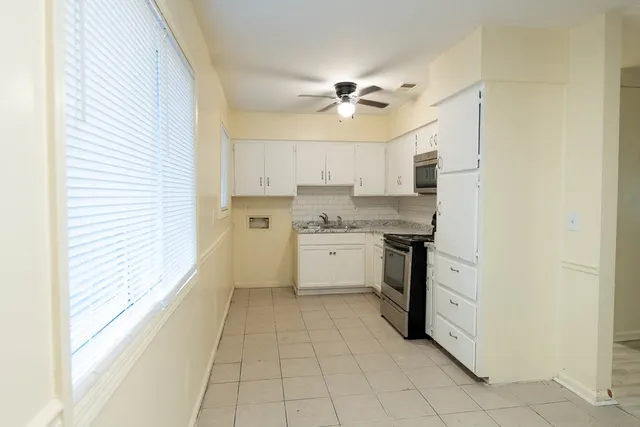 a kitchen with a stove a sink and a refrigerator