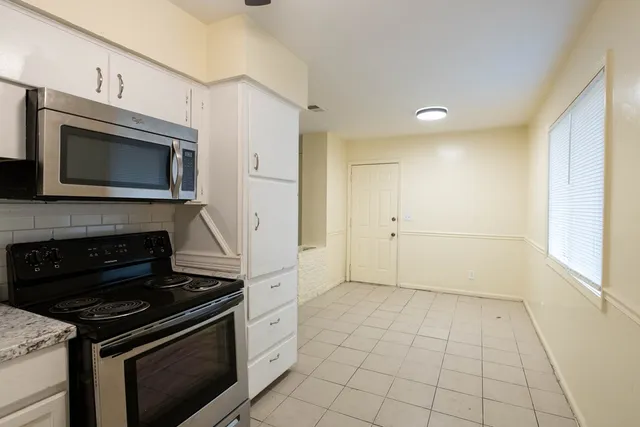 a kitchen with a stove and a microwave