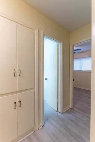 a view of a room with wooden floor