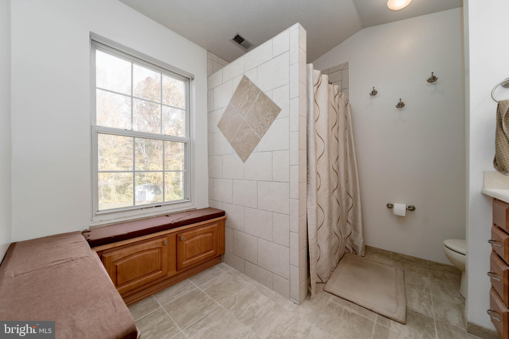 620 Small Reward Road Huntingtown, MD 20639 - Photo 16 of 33 a bedroom with a bed and a window