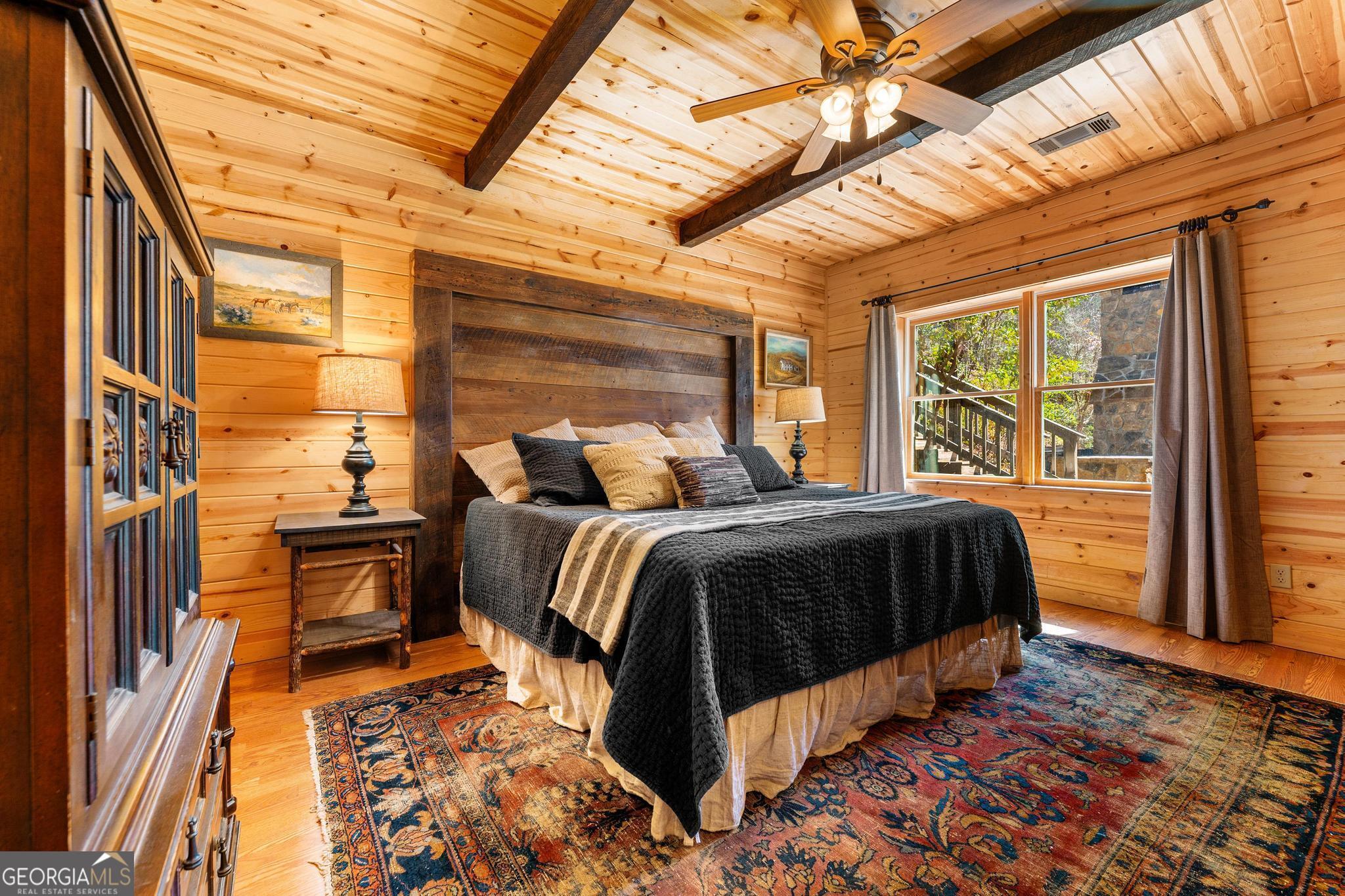 310 Blue Ridge Drive Sautee Nacoochee, GA 30571 - Photo 33 of 78 a bedroom with a bed and wooden floor