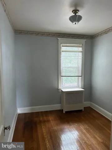 a view of room with hardwood floor and window