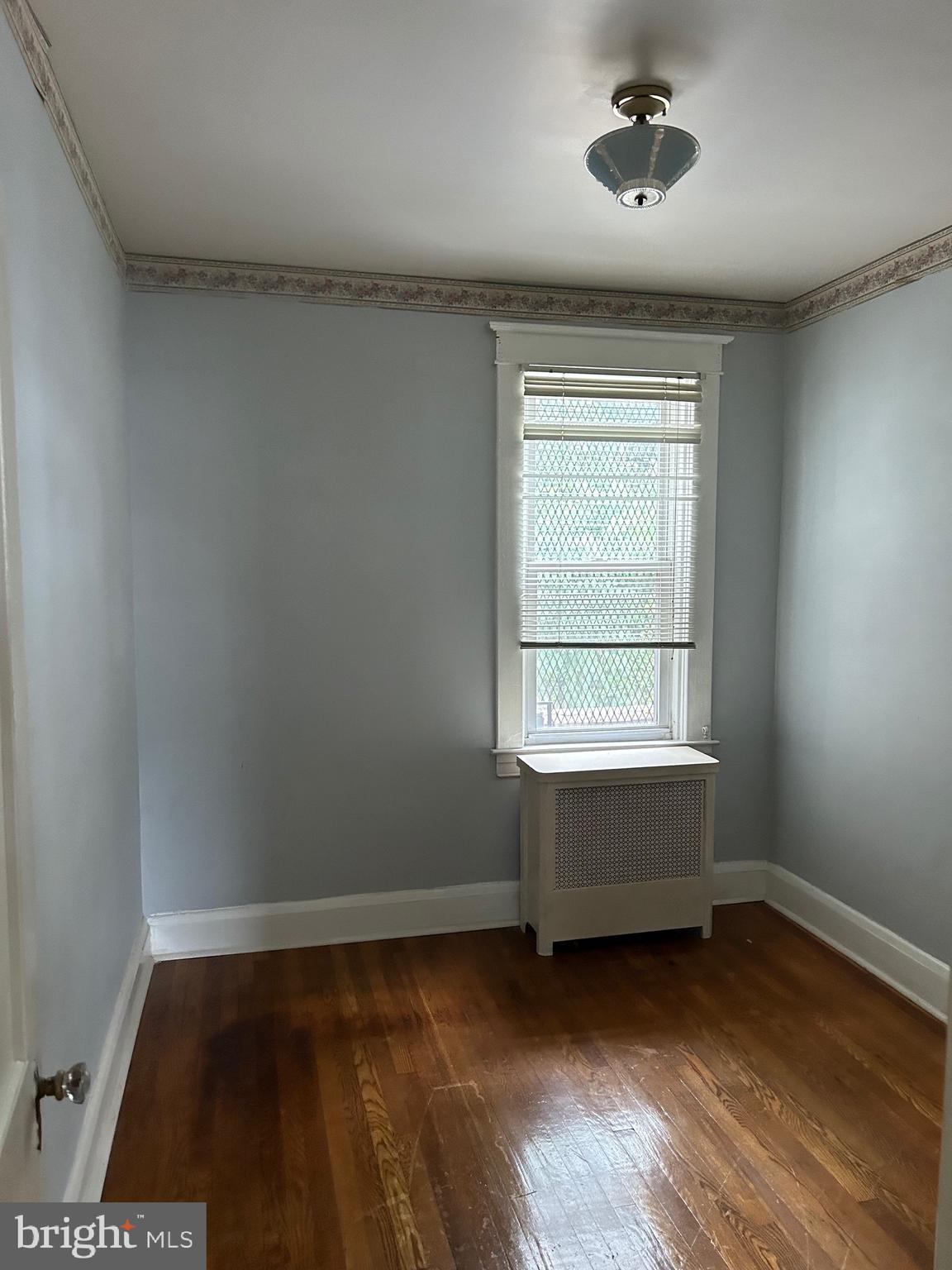 3216 Burleith Avenue Baltimore, MD 21215 - Photo 11 of 14 a view of room with hardwood floor and window