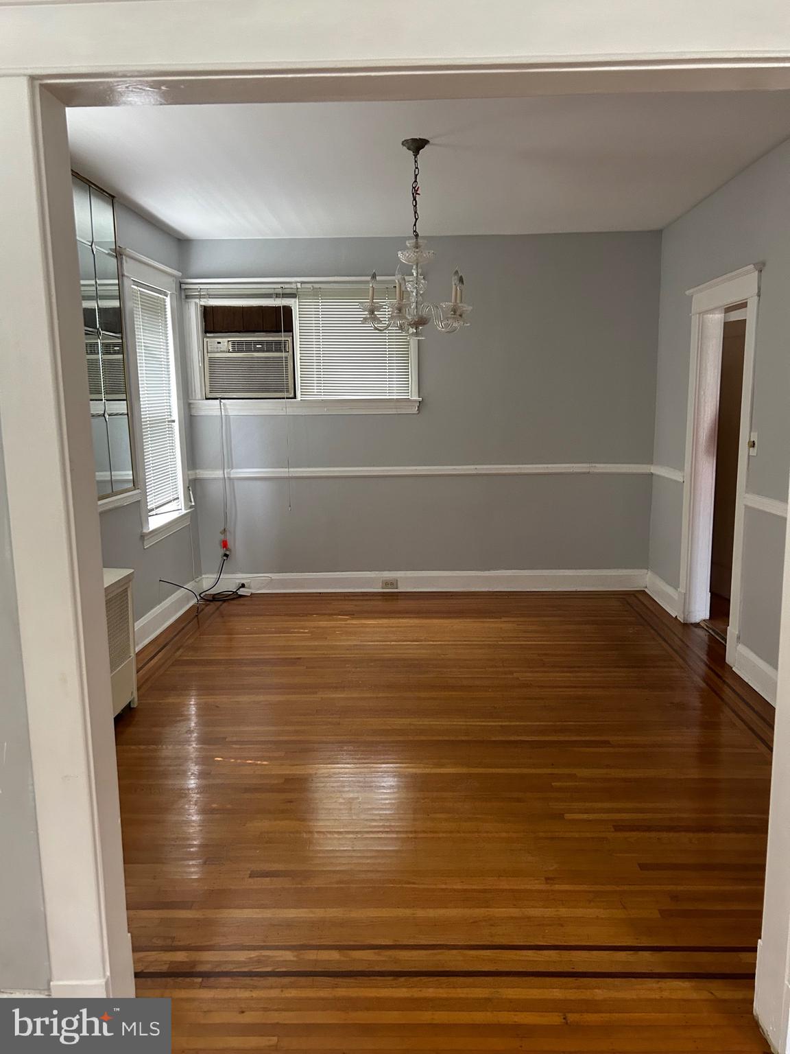 3216 Burleith Avenue Baltimore, MD 21215 - Photo 5 of 14 a view of an empty room with wooden floor and a window