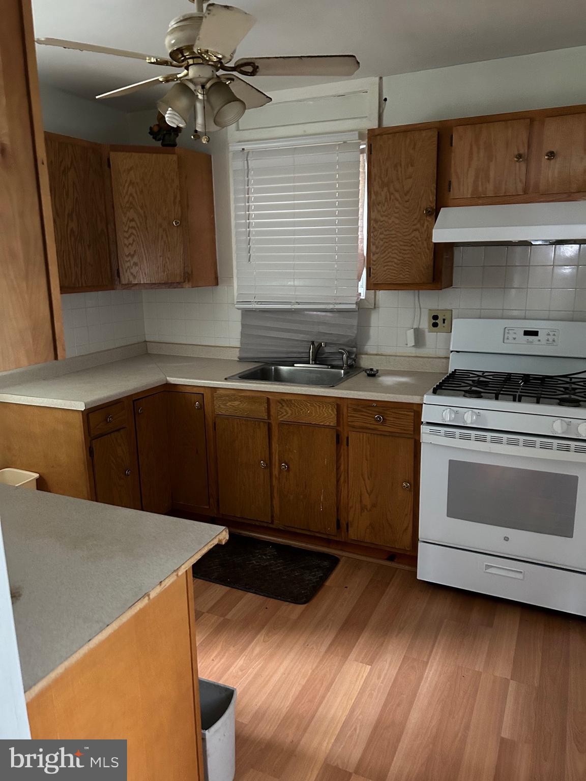 3216 Burleith Avenue Baltimore, MD 21215 - Photo 6 of 14 a kitchen with stainless steel appliances a stove a sink and a refrigerator
