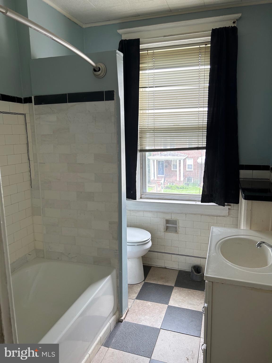 3216 Burleith Avenue Baltimore, MD 21215 - Photo 8 of 14 a bathroom with a sink a toilet and a bathtub