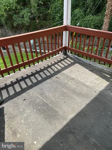 a view of wooden deck and a yard with swimming pool