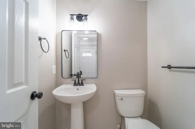 a bathroom with a toilet sink shower and mirror