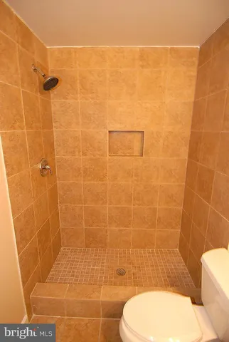 a bathroom with a toilet and a shower
