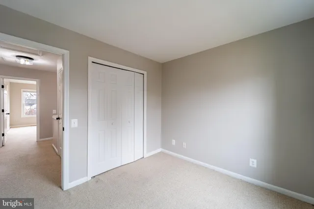 a view of an empty room and closet area