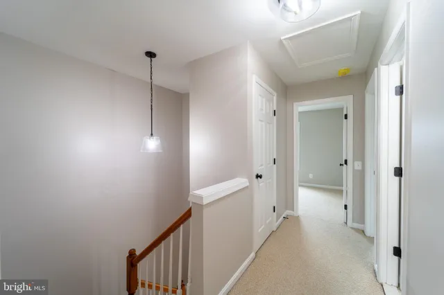 a view of a hallway with closet and wooden floor