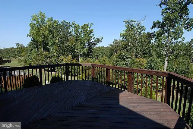 a view of wooden deck and a backyard