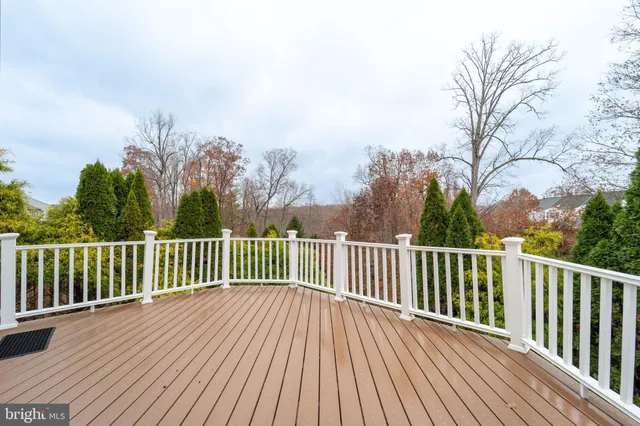 a view of balcony with wooden floor and fence