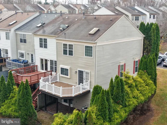 a view of a patio with table and chairs potted plants and large tree