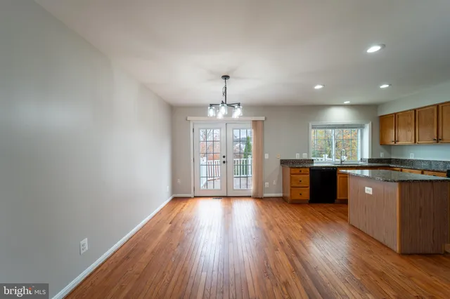 a view of kitchen with wooden floor and window