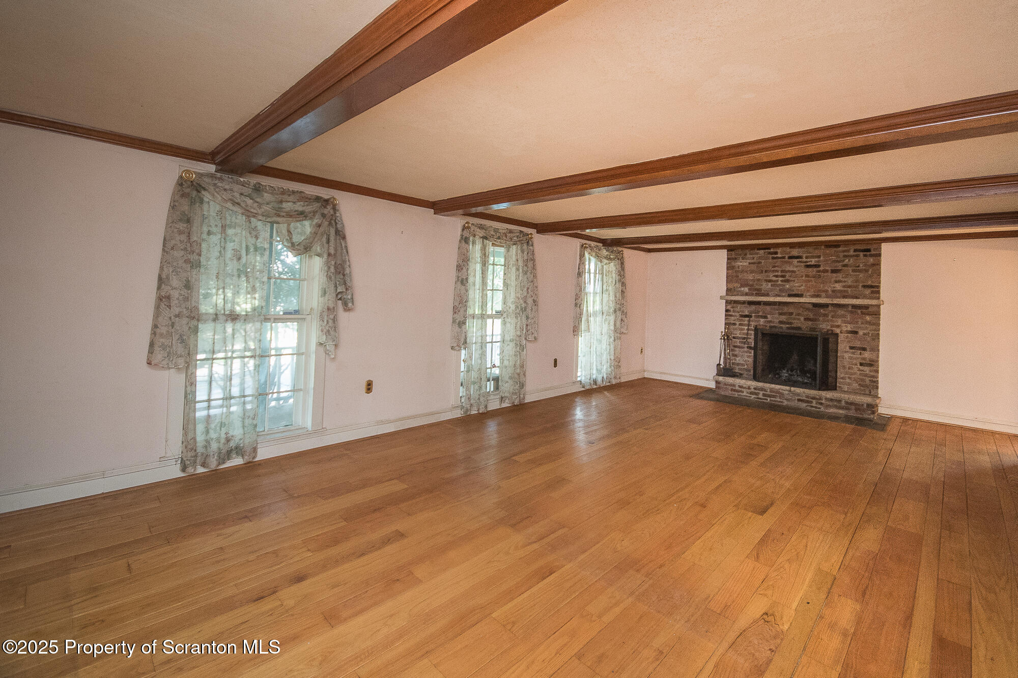 612 Clinton Street Waverly, PA 18471 - Photo 19 of 44 a view of empty room with wooden floor and fireplace