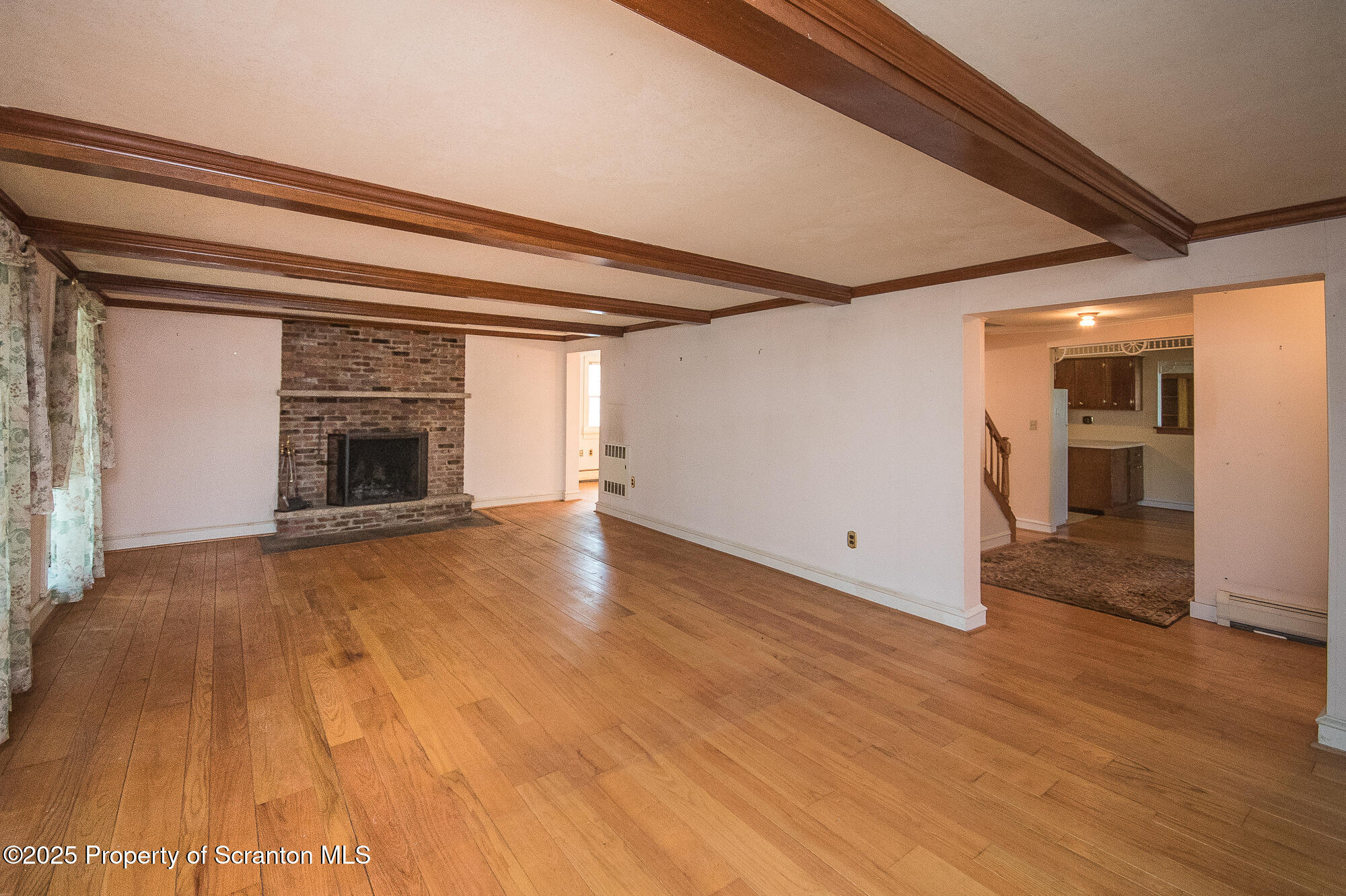 612 Clinton Street Waverly, PA 18471 - Photo 20 of 44 a view of empty room with wooden floor and fireplace