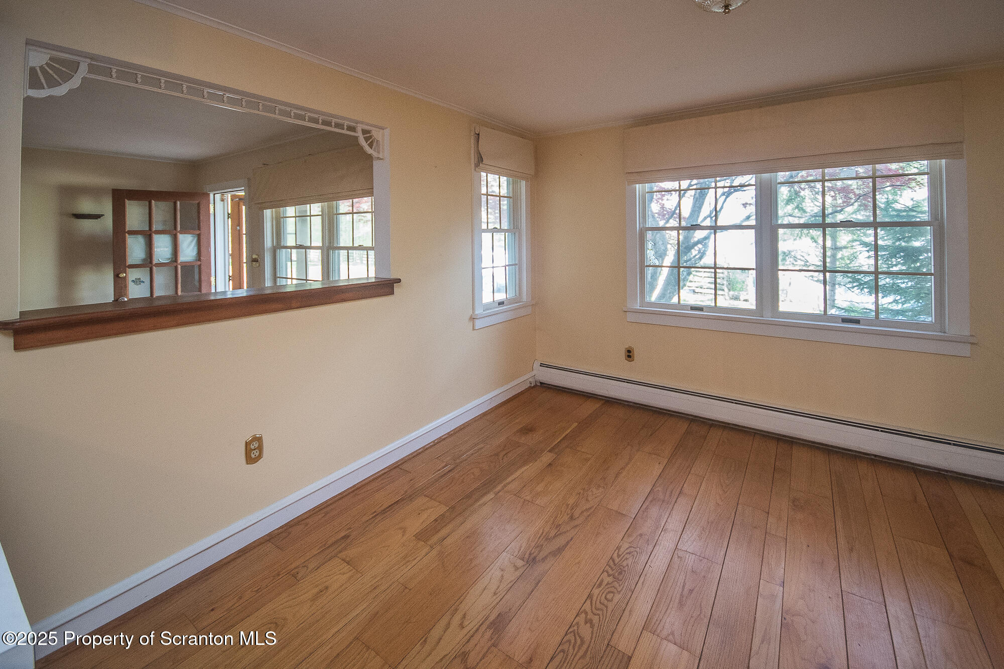 612 Clinton Street Waverly, PA 18471 - Photo 24 of 44 a view of an empty room with wooden floor and a window