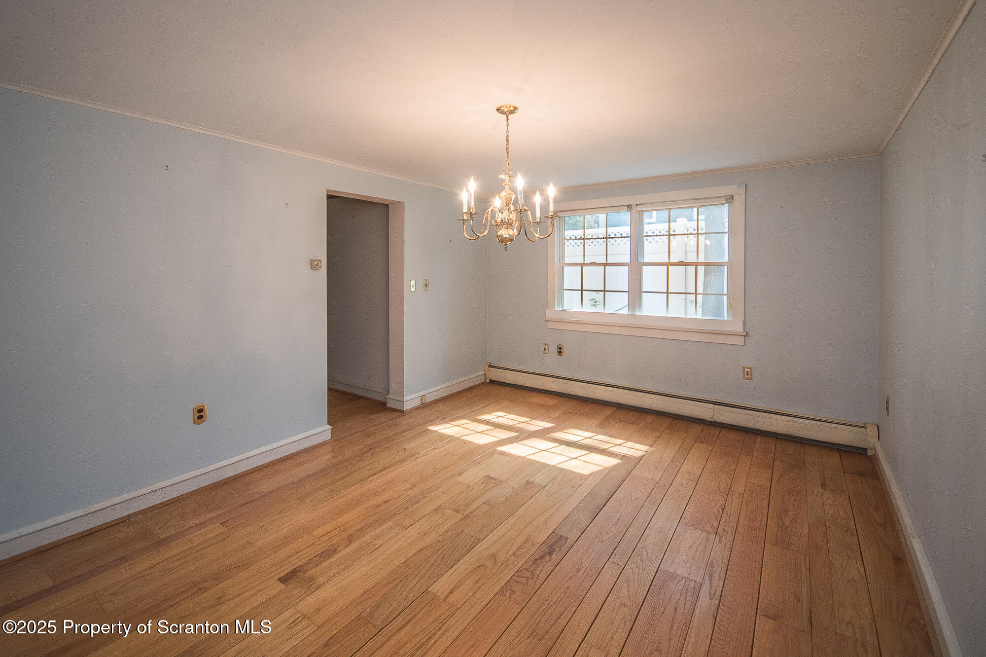 612 Clinton Street Waverly, PA 18471 - Photo 28 of 44 an empty room with wooden floor and windows