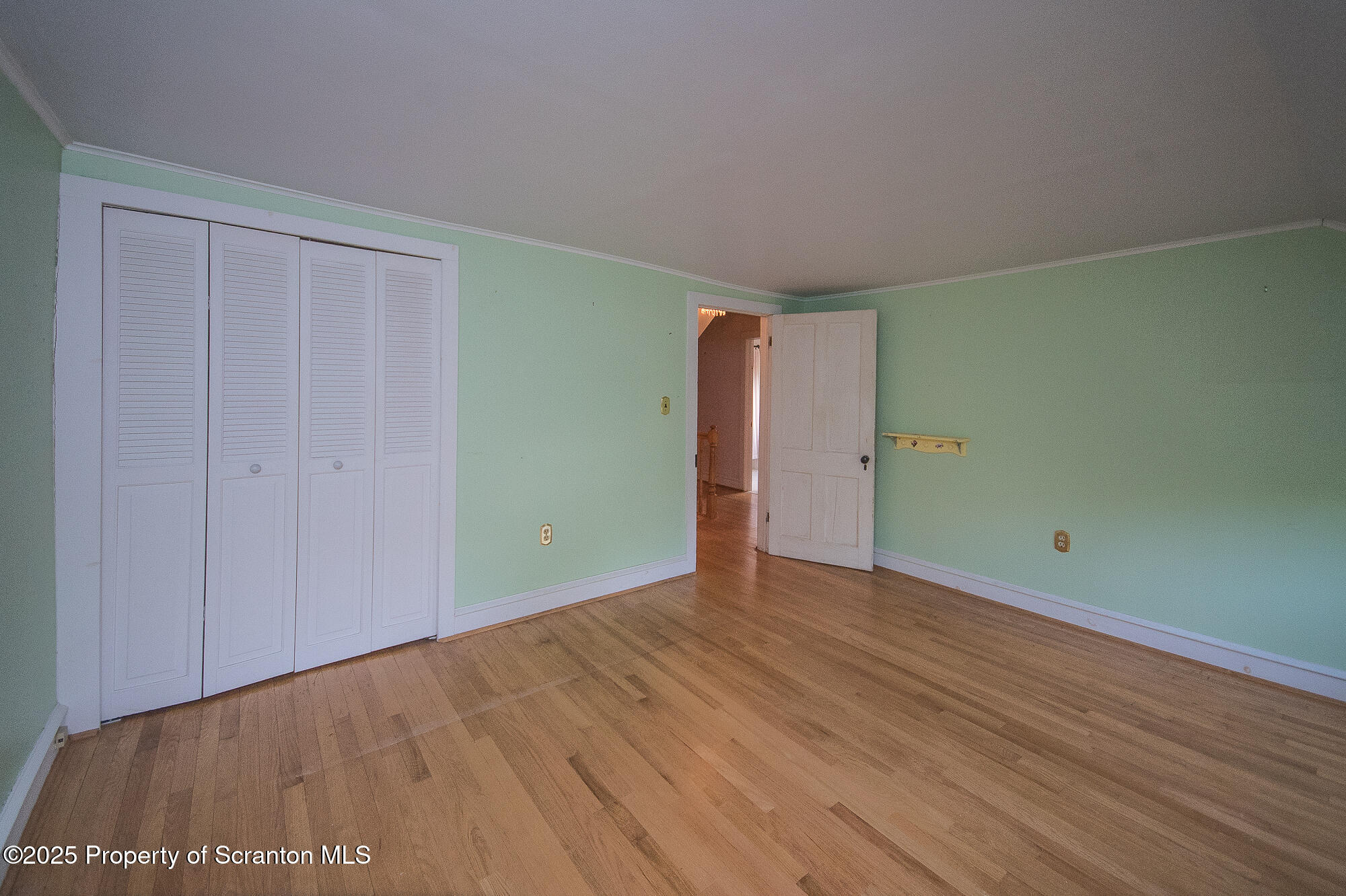 612 Clinton Street Waverly, PA 18471 - Photo 31 of 44 a view of an empty room with wooden floor