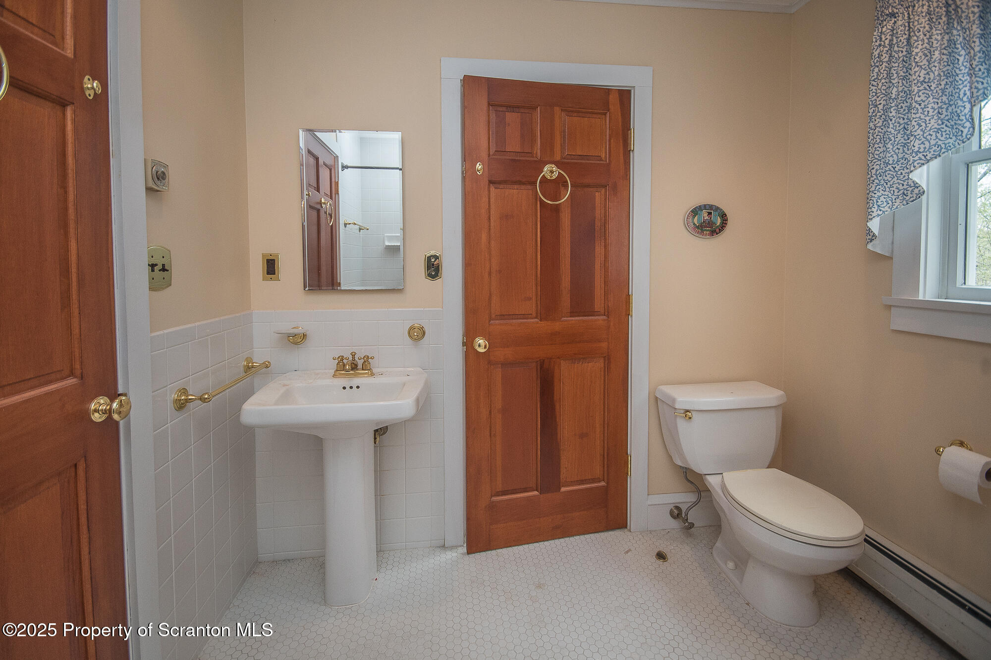 612 Clinton Street Waverly, PA 18471 - Photo 35 of 44 a bathroom with a toilet sink shower and mirror