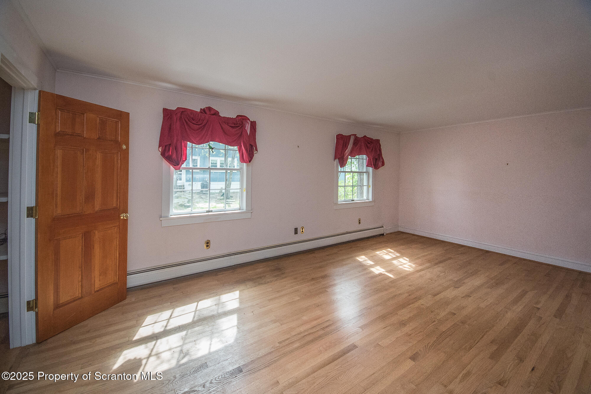 612 Clinton Street Waverly, PA 18471 - Photo 37 of 44 an empty room with wooden floor and windows