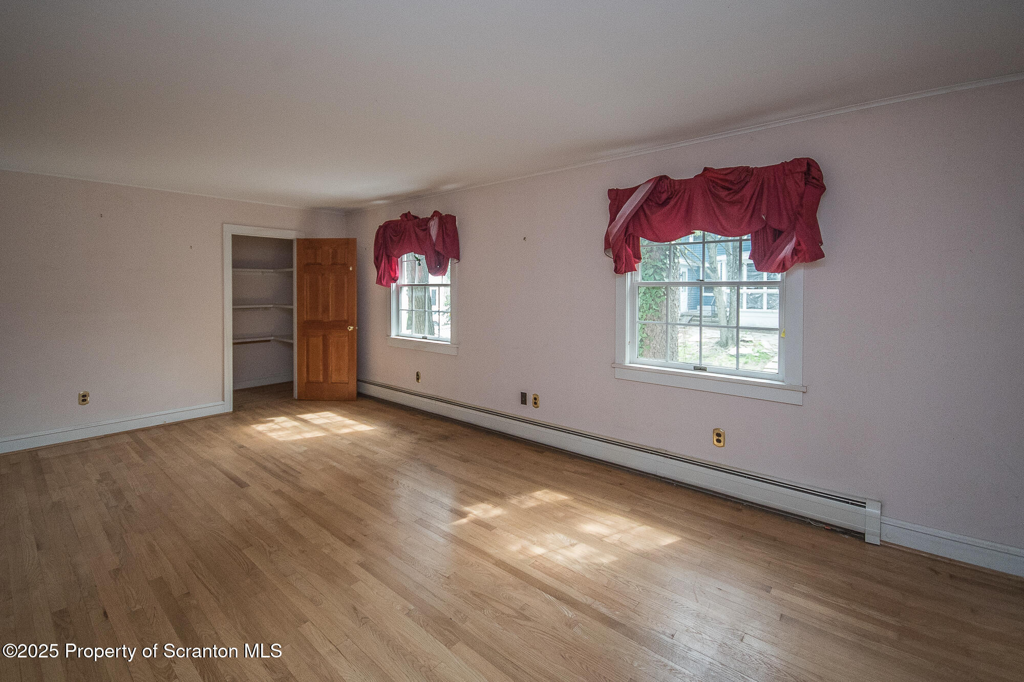 612 Clinton Street Waverly, PA 18471 - Photo 38 of 44 an empty room with windows and wooden floor