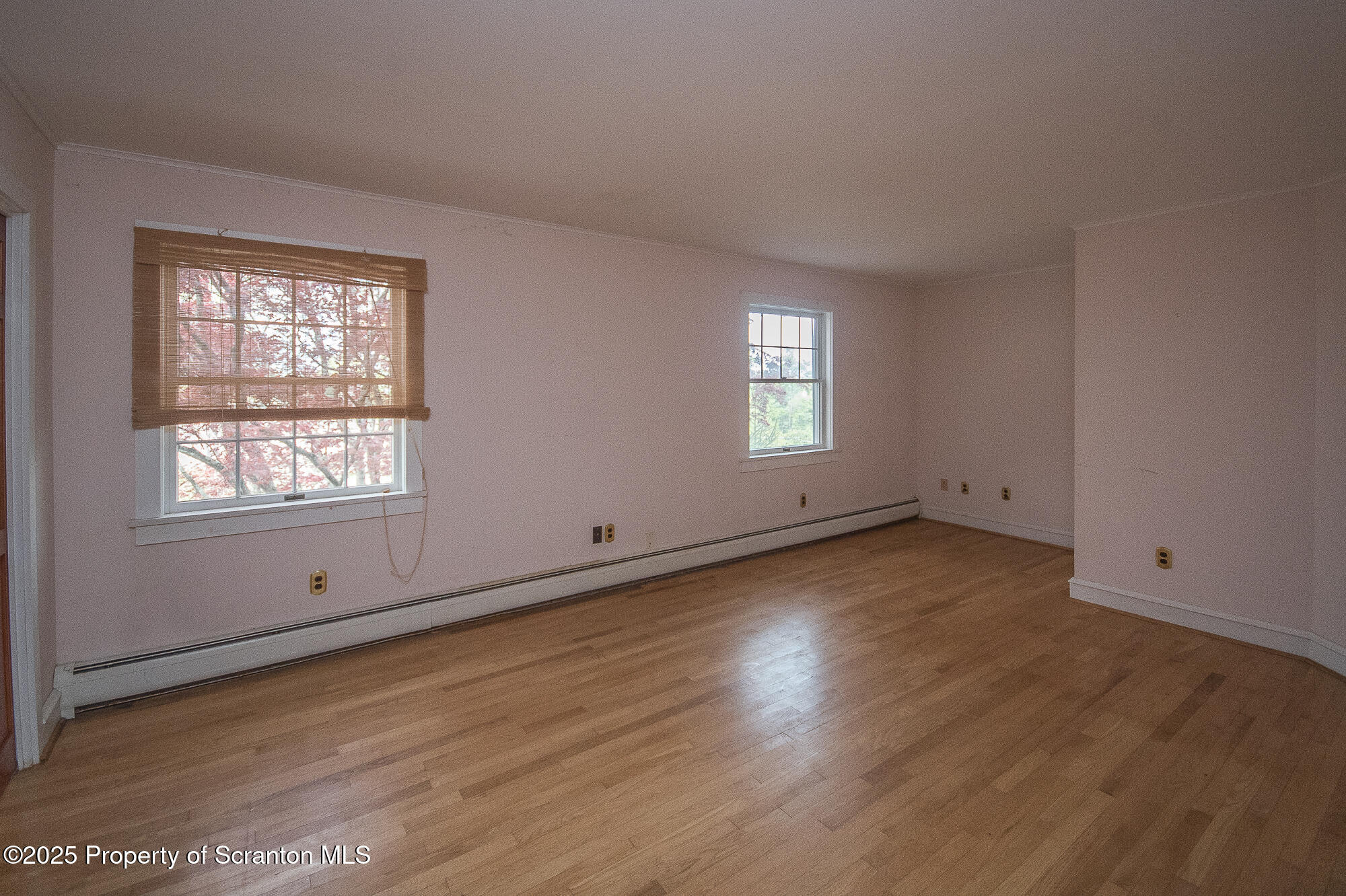 612 Clinton Street Waverly, PA 18471 - Photo 39 of 44 an empty room with wooden floor and windows