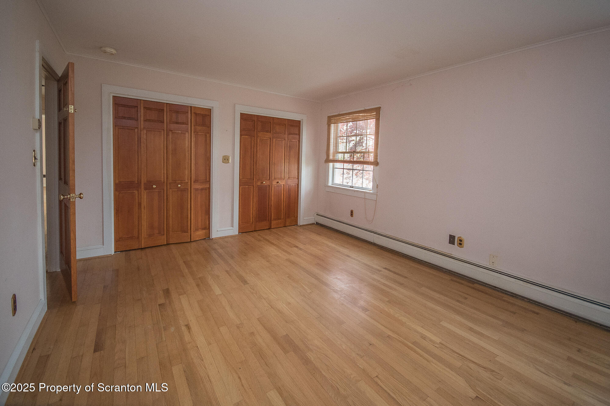 612 Clinton Street Waverly, PA 18471 - Photo 40 of 44 a view of an empty room with wooden floor and a window