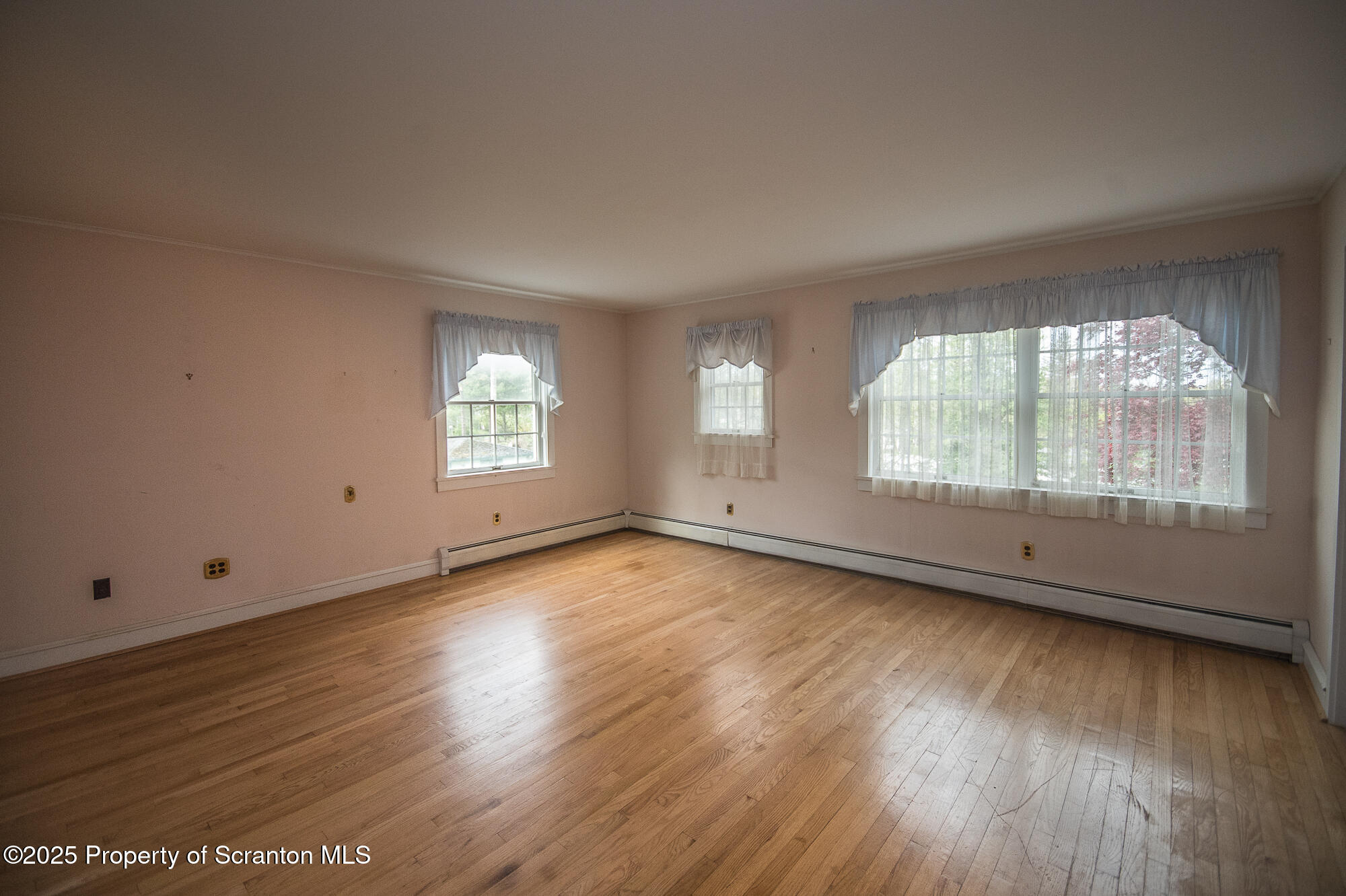 612 Clinton Street Waverly, PA 18471 - Photo 41 of 44 an empty room with wooden floor and windows