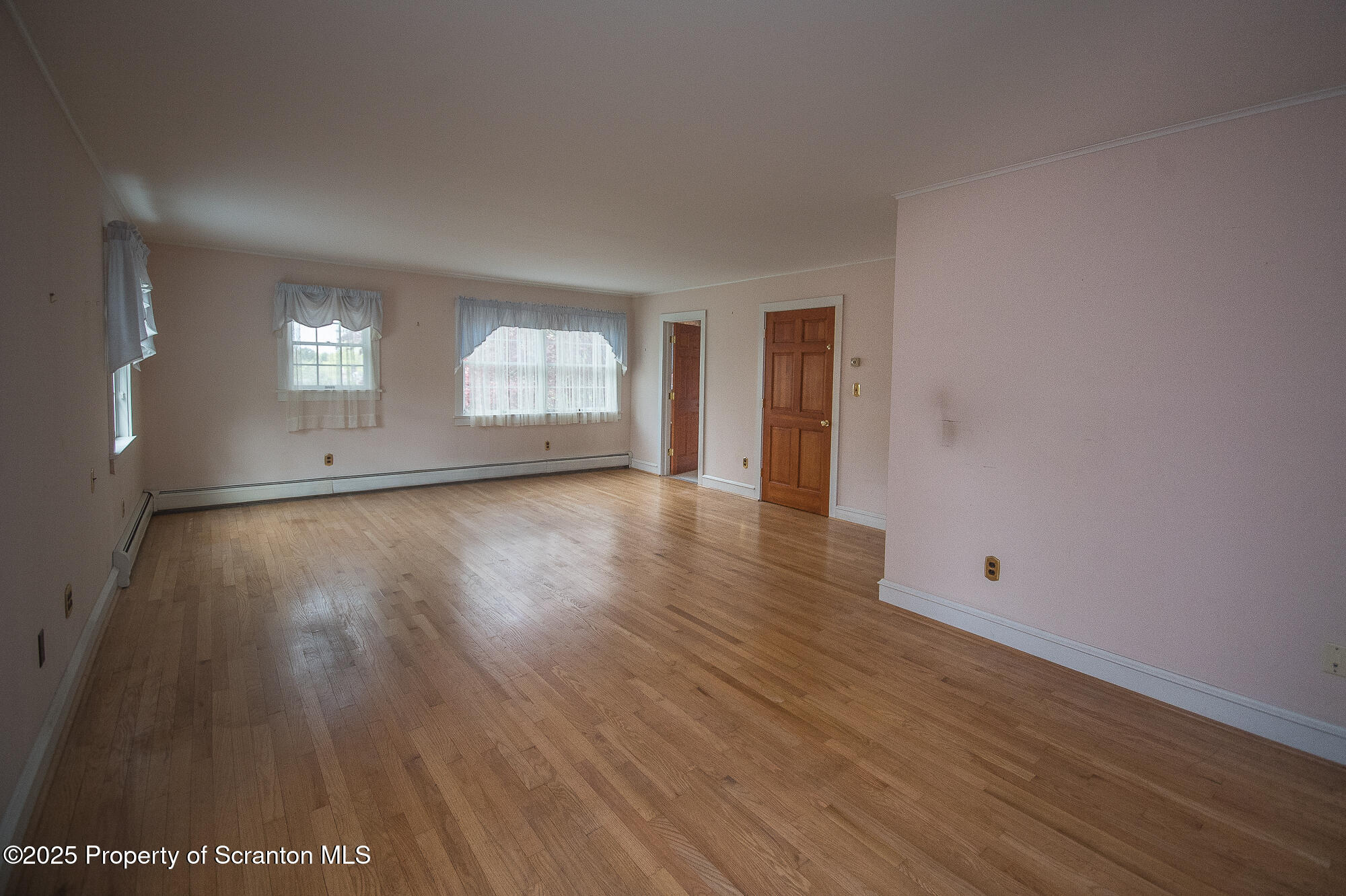 612 Clinton Street Waverly, PA 18471 - Photo 42 of 44 a view of an empty room with wooden floor and a window