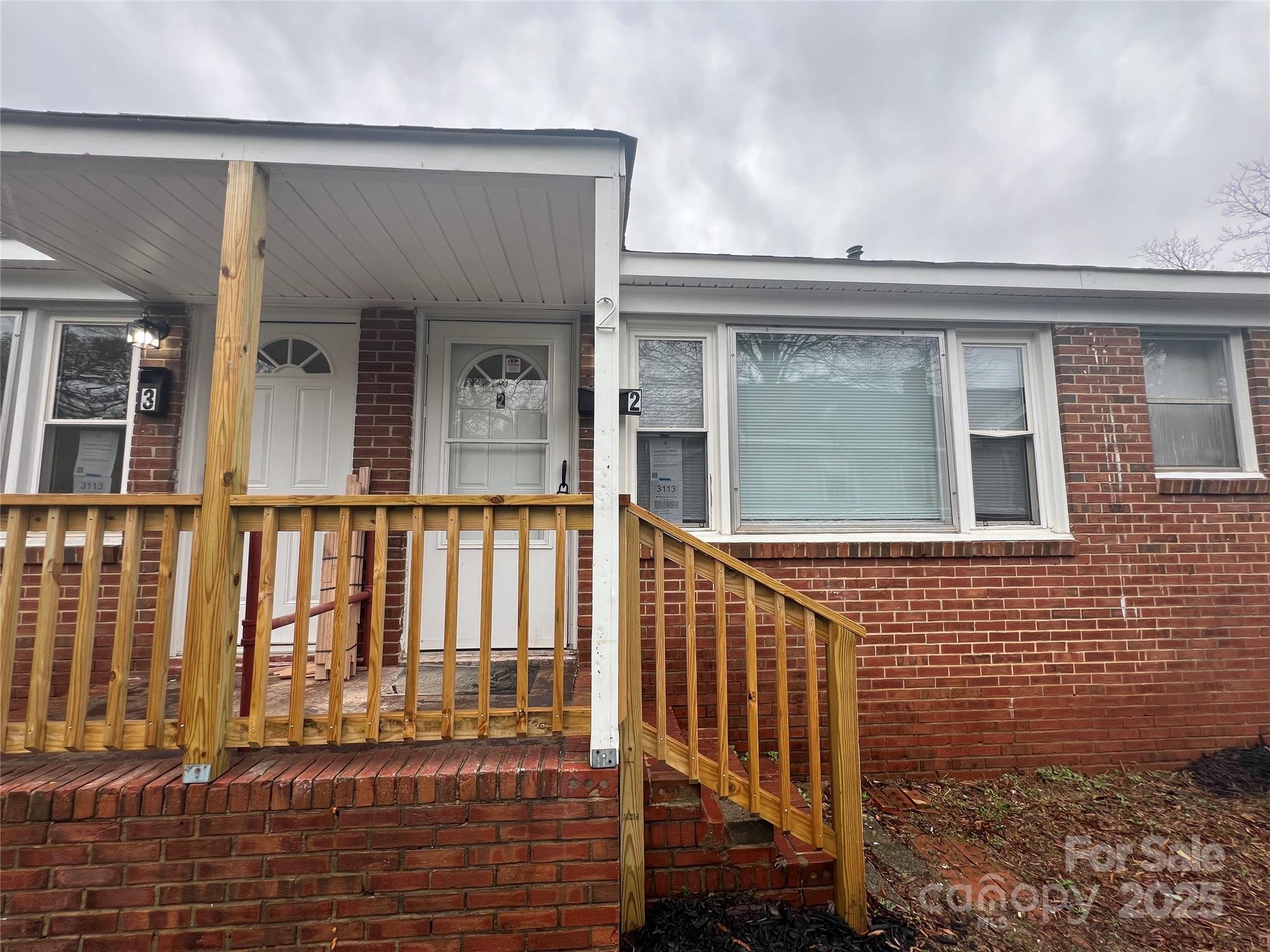 3113 Tuckaseegee Road Charlotte, NC 28208 - Photo 1 of 12 a view of a brick house with many windows