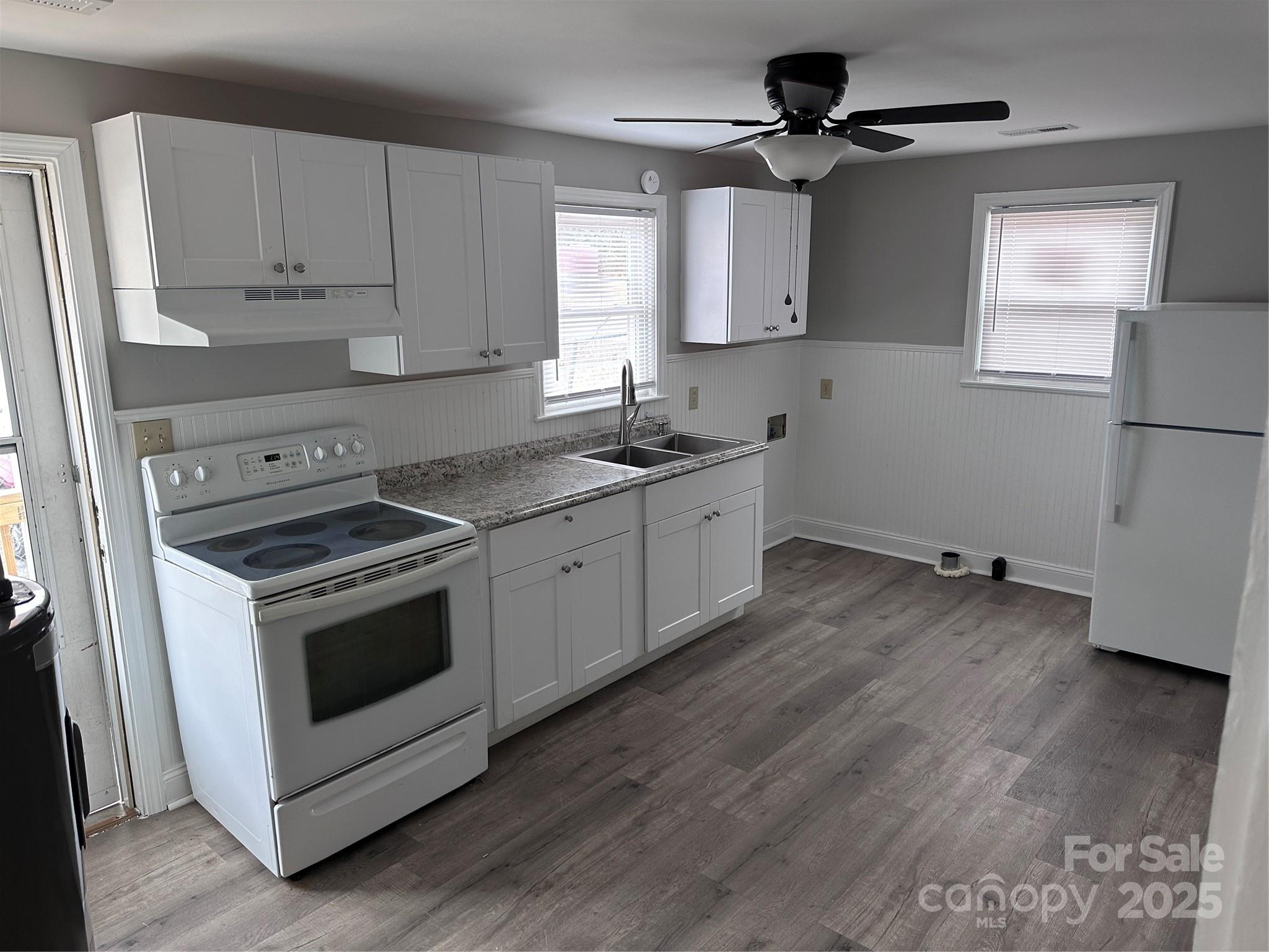 3113 Tuckaseegee Road Charlotte, NC 28208 - Photo 3 of 12 a kitchen with a stove a sink and a refrigerator