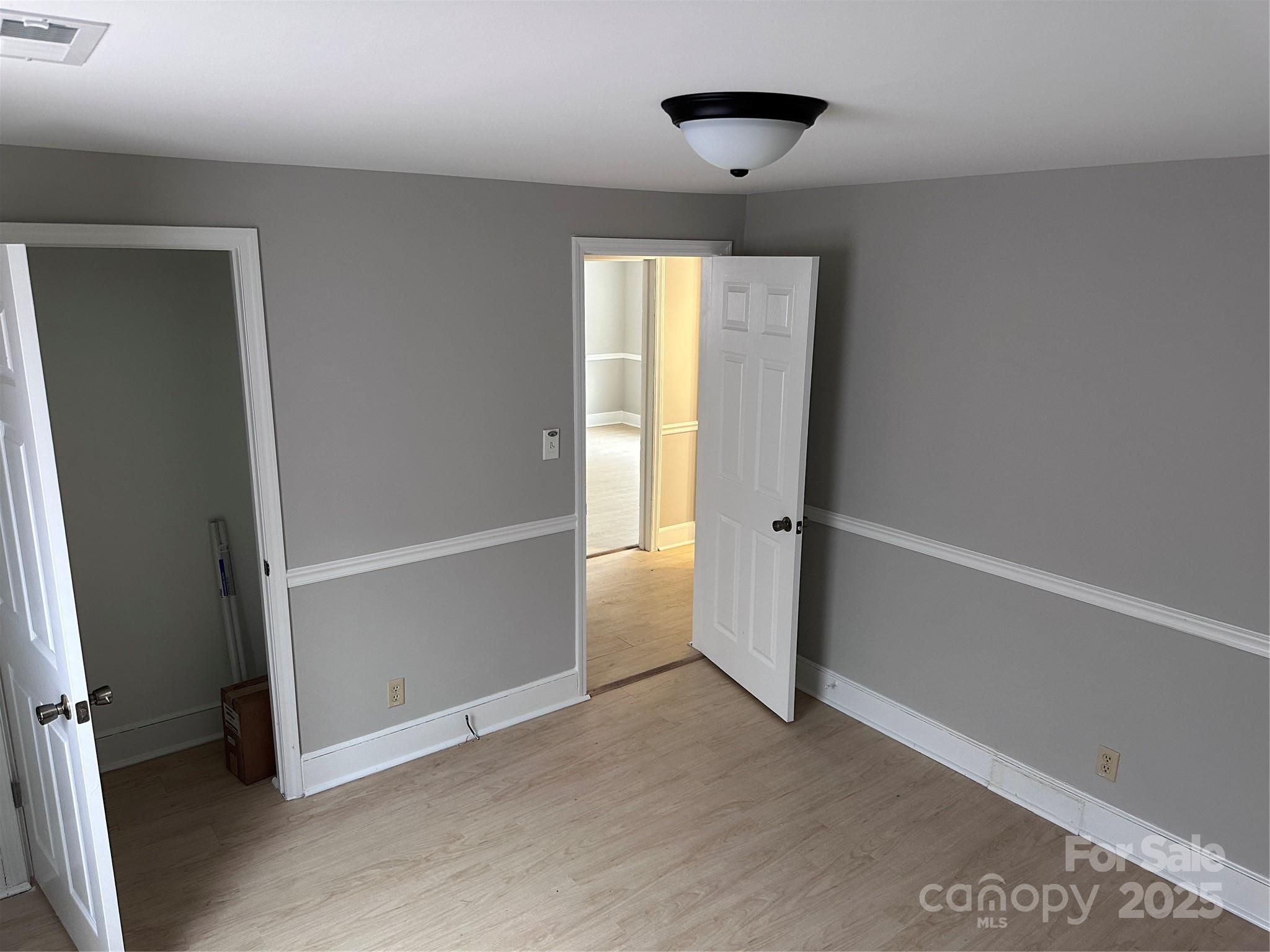3113 Tuckaseegee Road Charlotte, NC 28208 - Photo 5 of 12 wooden floor in an empty room with a window