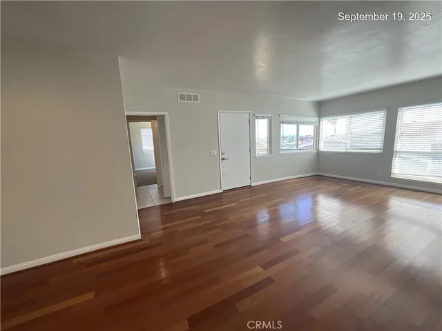 a bathroom with a granite countertop toilet and a sink