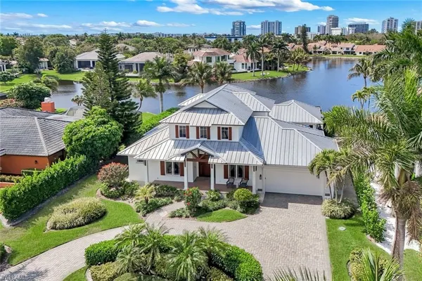 an aerial view of a house with a garden and lake view