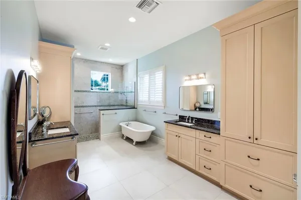 a bathroom with a granite countertop sink a toilet and bathtub