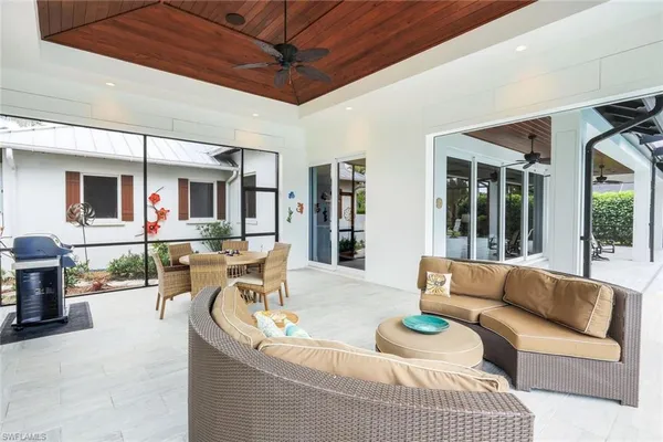a view of a swimming pool with a patio and a backyard