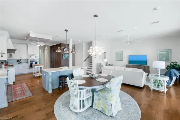 a living room with furniture a ceiling fan and a rug