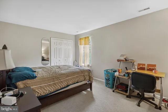 a bedroom with a bed and a chair