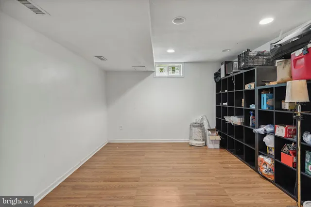 a room with a book shelf and wooden floor