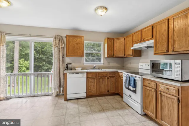 a kitchen with sink cabinets and window