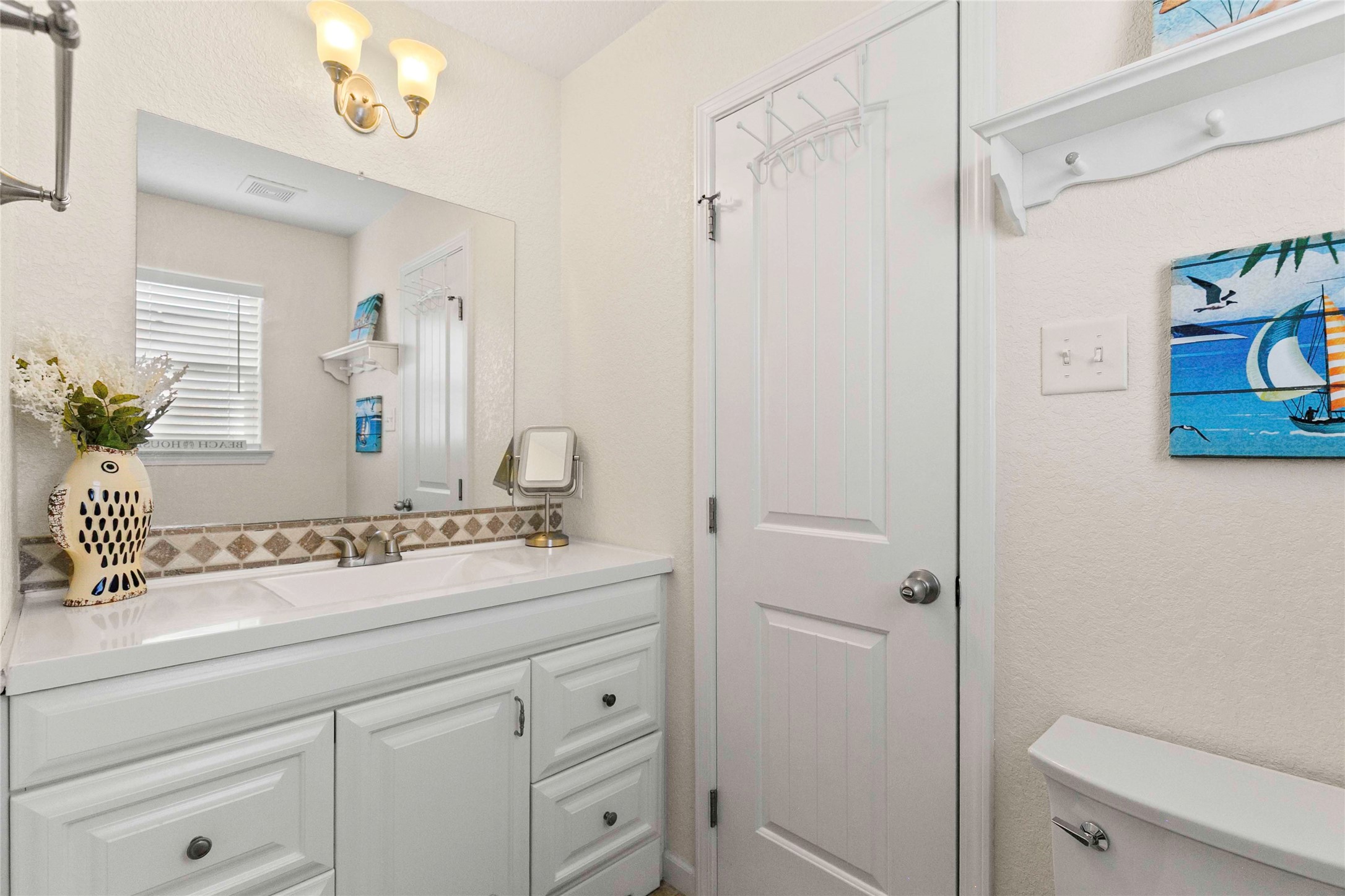 757 Bluewater Highway Surfside Beach, TX 77541 - Photo 22 of 44 a bathroom with a sink a toilet a shower and a mirror